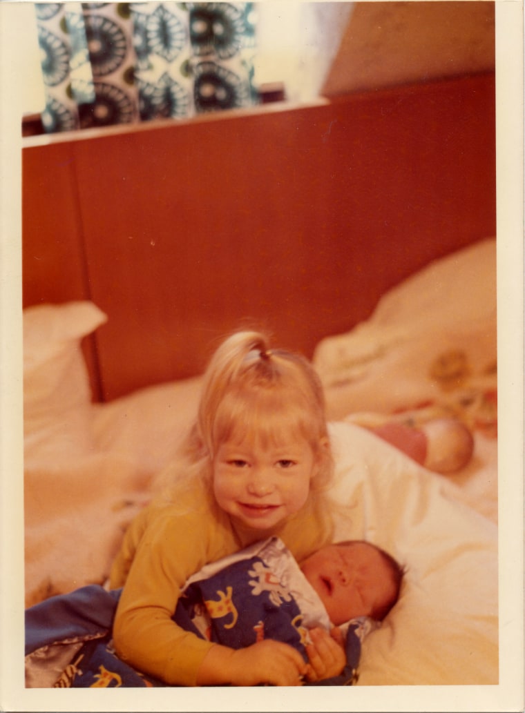 Condie holds her little sister as a baby.