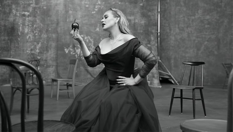 Adele revives the ballgown she posed in just days before the video dropped (and yes, she takes a bite of that symbolic apple).
