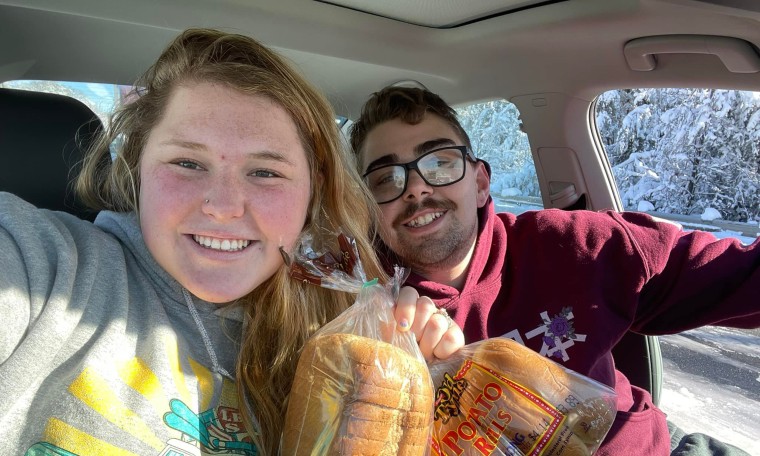 Casey Holihan and her husband, John Noe, with their bread from a Schmidt Baking Company truck.