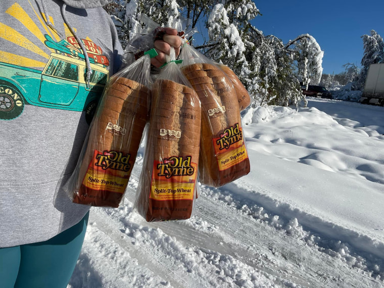 Casey Holihan and her husband John helped hand out the much-needed bread to nearby motorists who had been stuck for 20-plus hours without food. 
