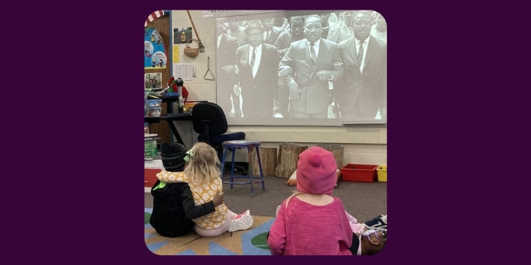 Two children at Gatewood Elementary in Minnetonka, Minnesota, embrace while watching a video of Martin Luther King, Jr.