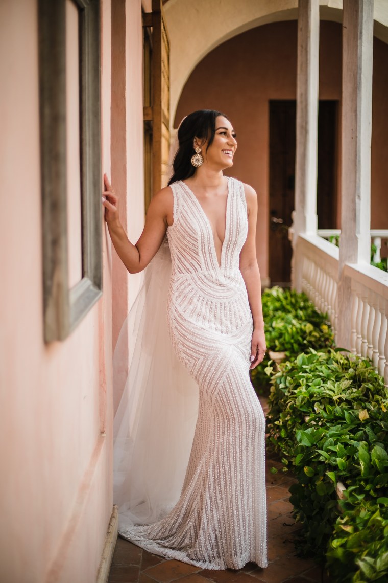 Radford paired the fairytale-worthy dress with a long veil and statement earrings, and kept the rest of her look simple with an all-natural makeup look and her hair loose around her shoulders. 
