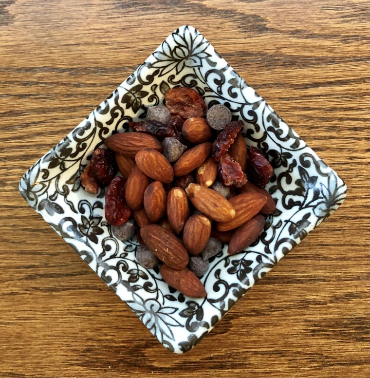 An ounce of nuts with 2 tablespoons dried cranberries and 1 tablespoon chocolate chips.