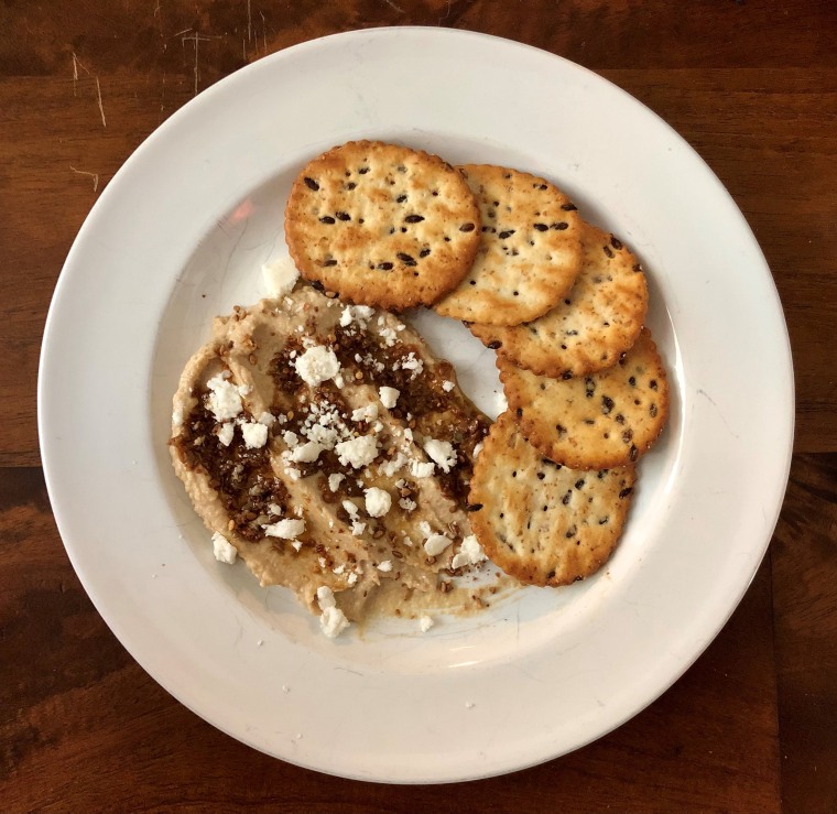 Sprinkles always make it better. Back to Nature crackers with hummus, tapenade and a feta garnish.