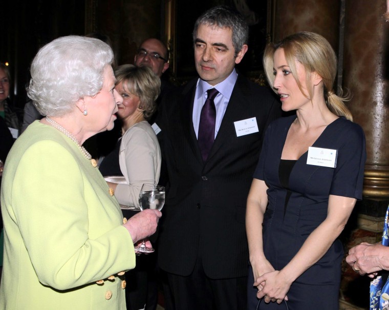 Queen Elizabeth greets Gillian Anderson and Rowan Atkinson