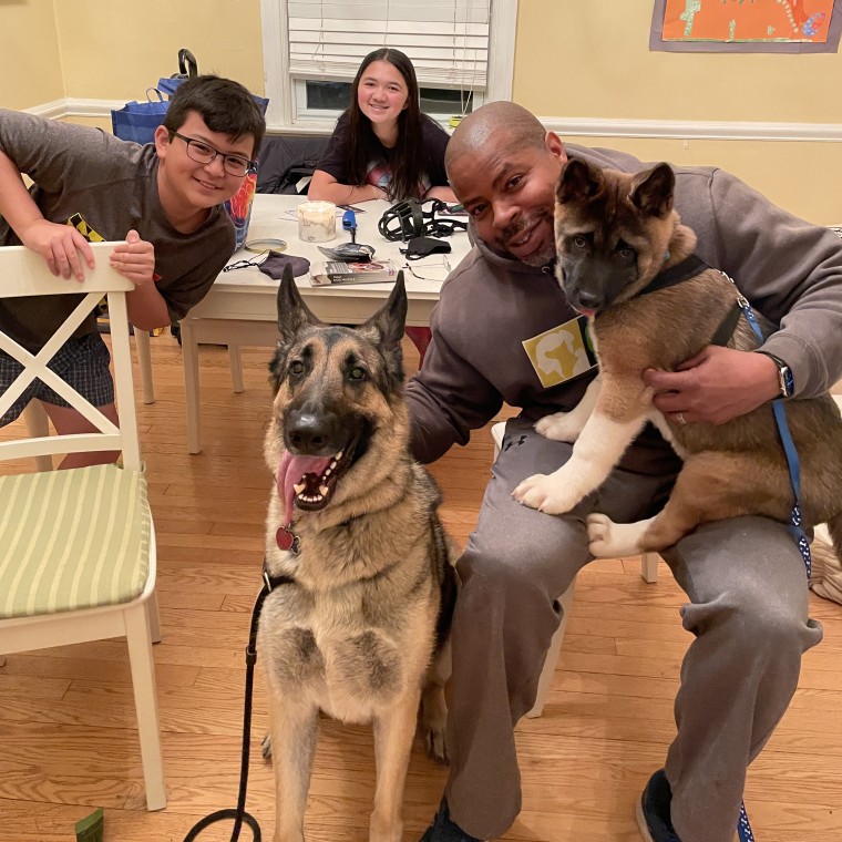 CARE founder James Evans smiles at home with his children, Andrew, 11, and Lila, 13, and their beloved rescue dogs, Guapo, 3, and Rocky, 4 months. The family was rejected for dog adoption by rescue organizations a dozen times before a colleague connected them with Rocky.