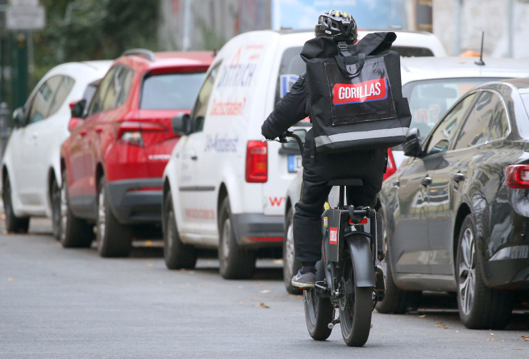 An employee of the food delivery service Gorillas cycles through the streets of Berlin.