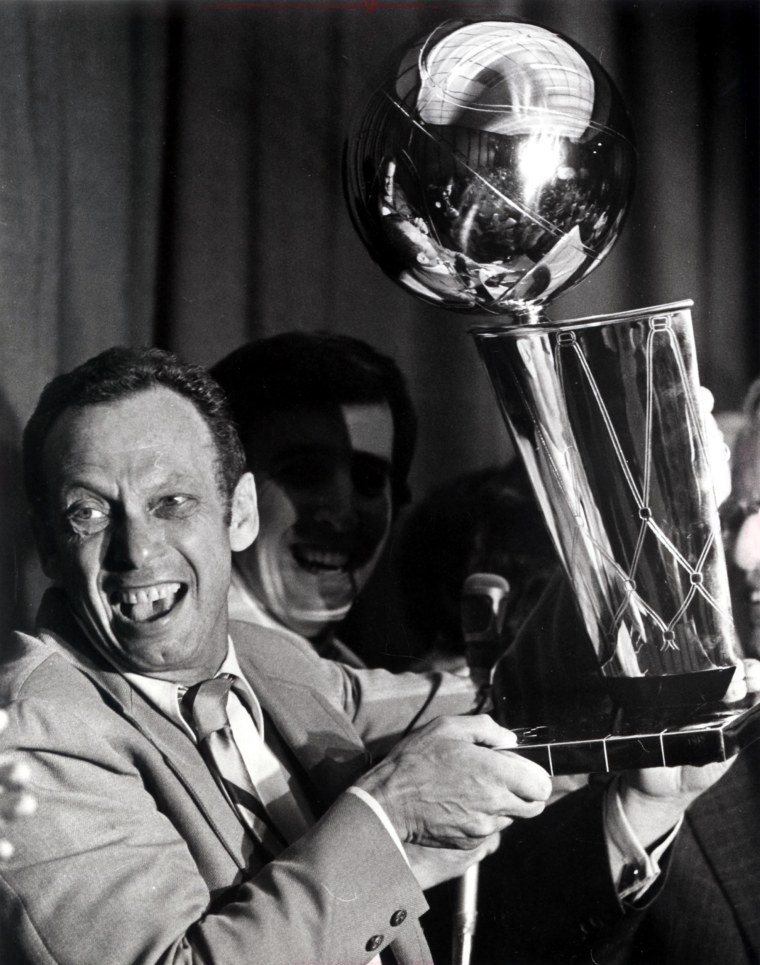 Bullets owner Abe Pollin holds the NBA championship trophy after his team's win in 1978.