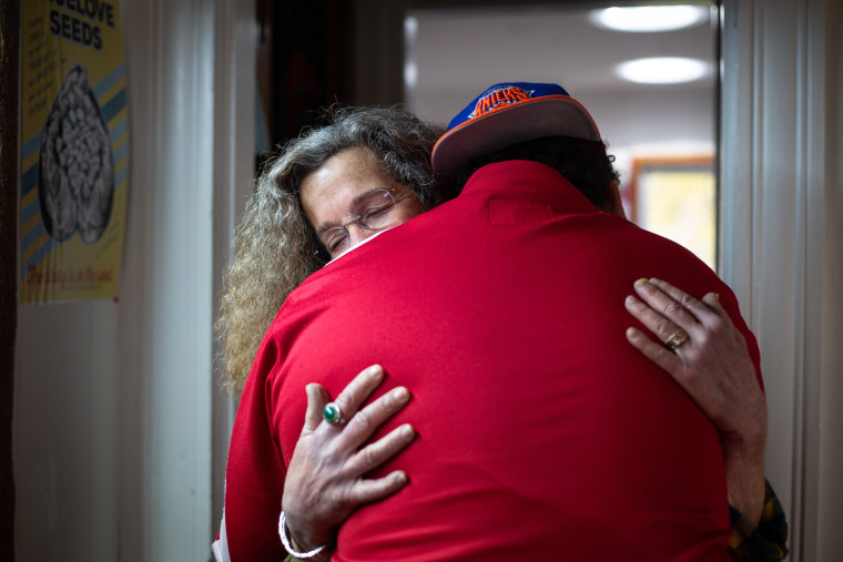 Cathy Austrian hugs her teenage child, who she says was traumatized by an encounter with police in Burlington, Vermont, last spring.