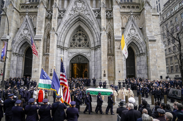 Image: New York Police pall bearers carry the casket of Officer Wilbert Mora to a hearse following Mora's funeral service at St. Patrick's Cathedral on Feb. 2, 2022, in New York.