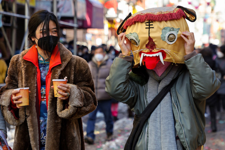 Image: A person wearing a tiger mask celebrates the beginning of the Lunar New Year in Manhattan's Chinatown on Feb. 01, 2022 in New York City.
