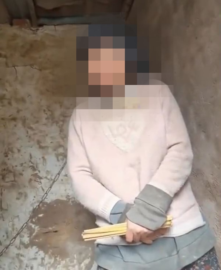 The woman was discovered chained by the neck in a filthy shack, in footage filmed late last month.