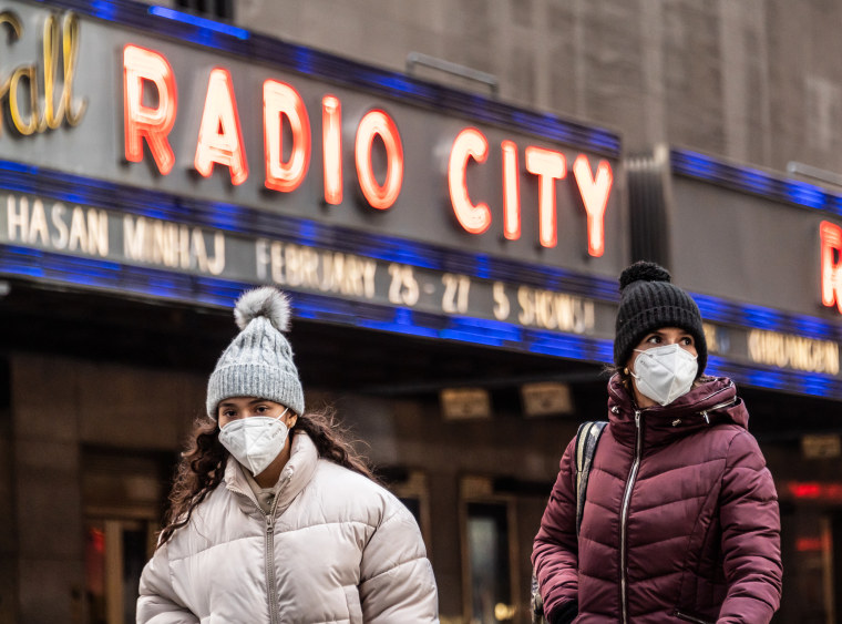 People walk outside Radio City Music Hall on Jan. 24, 2022 in New York.