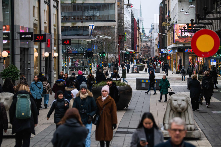 Image: People visit one of Stockholm's busiest shopping streets on Feb. 4, 2022.