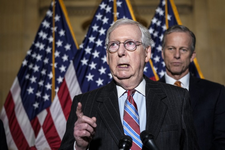 Image: Senate Minority Leader Mitch McConnell speaks to reporters following a lunch meeting with Senate Republicans on Capitol Hill on Feb. 8, 2022.