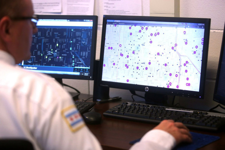 Image:  A police officer monitors ShotSpotter and other crime detection programs at the Chicago Police Department 7th District Strategic Decision Support Center in 2017.