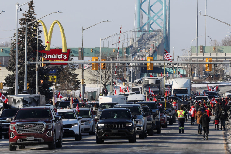 Image: Vehicles block the route leading from the Ambassador Bridge, linking Detroit and Windsor, as truckers and their supporters continue to protest vaccine mandates, in Windsor, Ontario, Canada, on Feb. 8, 2022.