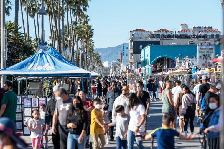 People walk along the Venice Beach Boardwalk on Feb. 6, 2022, in Los Angeles.