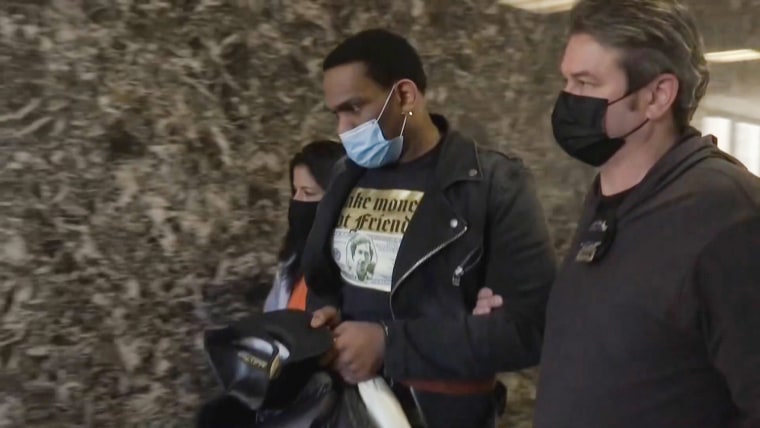 Law enforcement officials escort Kareem Mitchell to his court appearance in New York on Feb. 9, 2022.