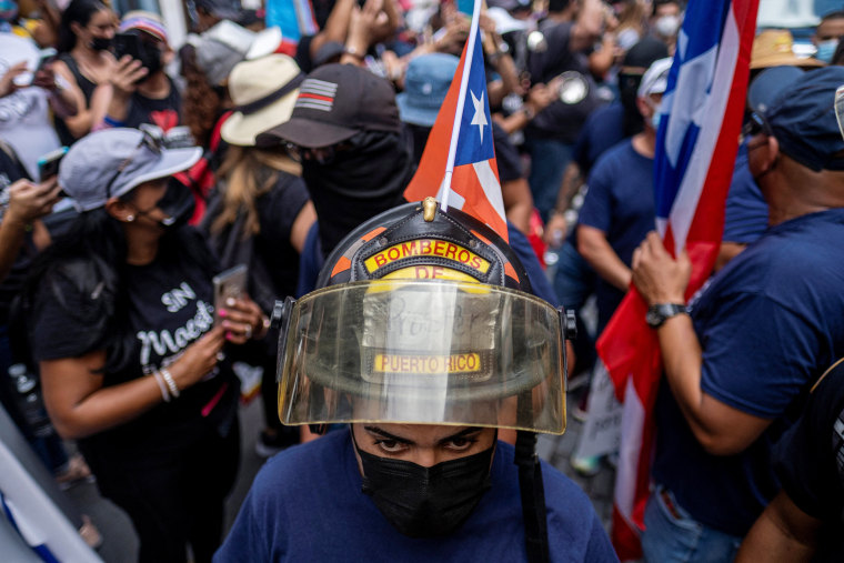 Image: Firefighters march during a protest in Old San Juan, Puerto Rico on Feb. 9, 2022.