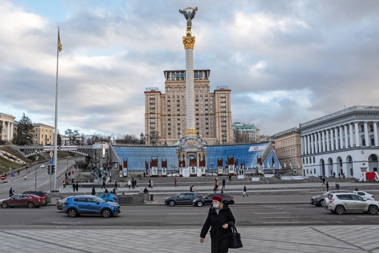 A woman walks in front of Independence Monument in Kyiv