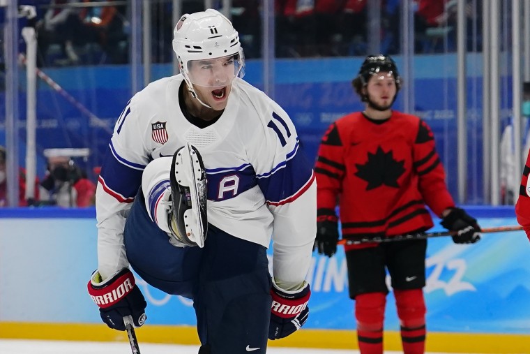 United States' Kenny Agostino (11) celebrates after scoring a goal against Canada during a preliminary round men's hockey game at the 2022 Beijing Winter Olympics on Saturday, Feb. 12, 2022, in Beijing.