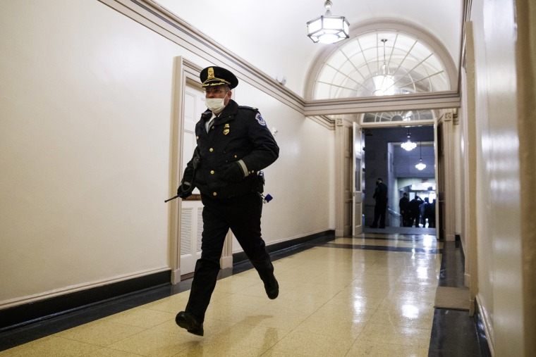 A Capitol Police officer responds to pro-Trump rioters inside the Capitol on Jan. 6, 2021.