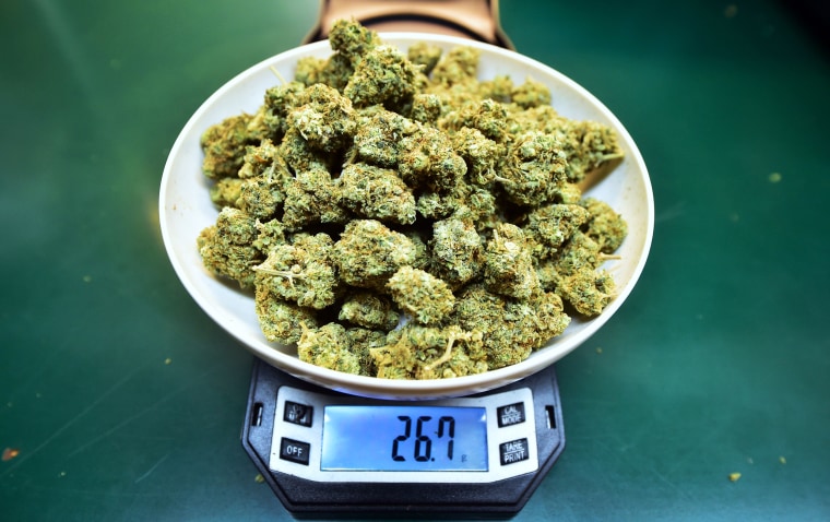Marijuana is weighed on a scale at Virgil Grant's dispensary in Los Angeles on Feb. 8, 2018.