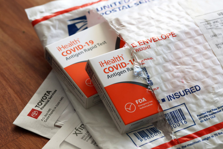 Free iHealth COVID-19 antigen rapid tests from the federal government sit on a U.S. Postal Service envelope after being delivered on Feb. 4, 2022, in San Anselmo, Calif.