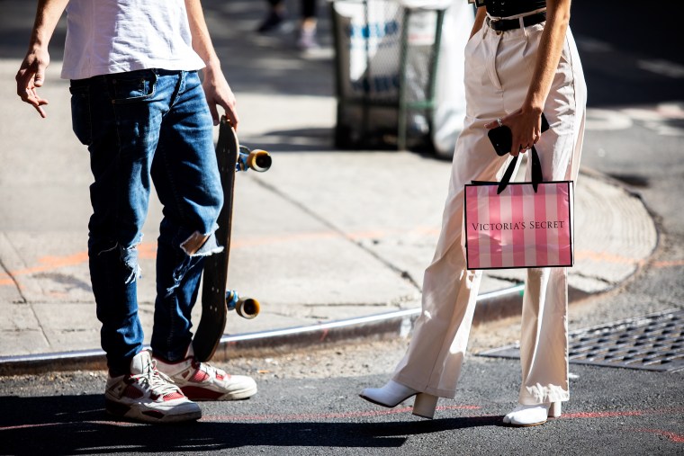 A pedestrian carries a Victoria's Secret shopping bag while waiting to cross a street in New York on  Sept. 25, 2019.