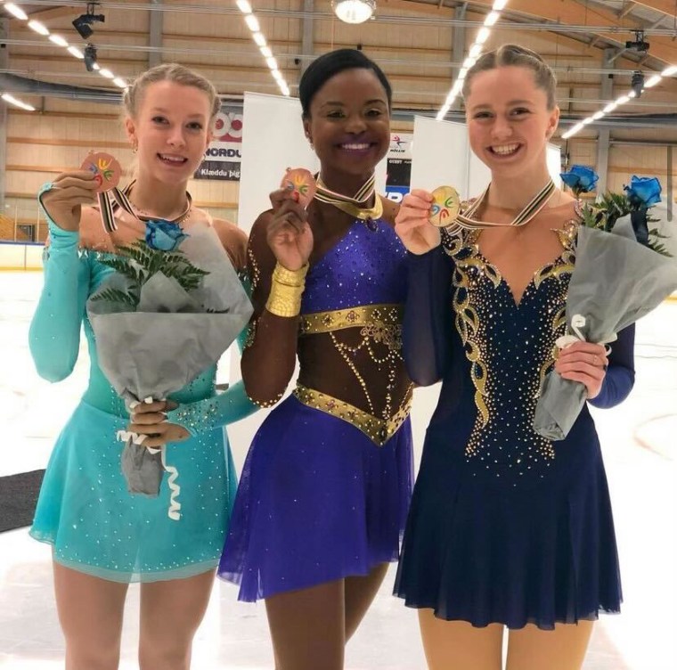 Louisa Warwin poses with a medal after a competition.