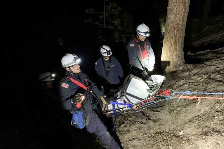 Firefighters rescue a woman on Feb. 14, 2022, in Reno, Nev., who was reported missing.