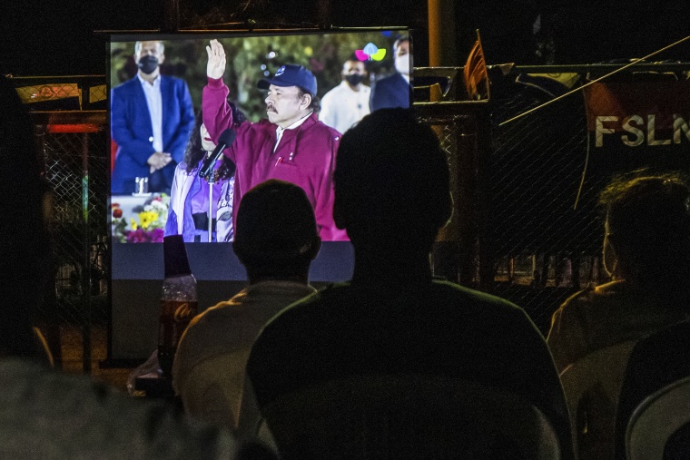 Residents watch the inauguration of current President Daniel Ortega, for is fourth consecutive term, on a giant screen set up at a park in the Julio Buitrago neighborhood of Managua, Nicaragua, on Jan. 10, 2022.