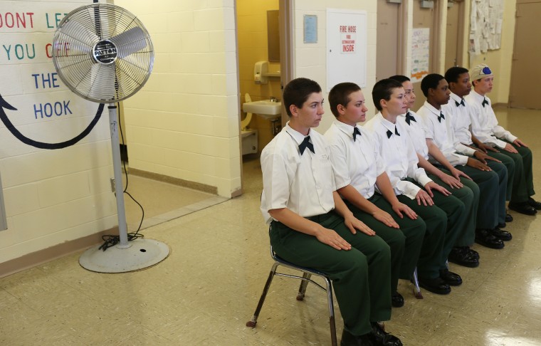 Image: Inmates sitting in a line at the Lakeview Shock Correctional Facility.