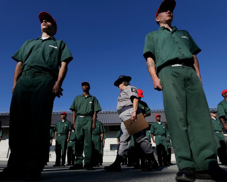 Correctional officer Juleigh Walker inspects inmates during morning formation at the Moriah Shock Incarceration Correctional Facility in Aug. 22, 2012, in Mineville, N.Y.