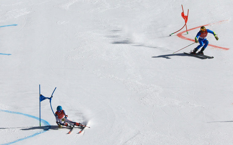River Radamus, left, of the United States races and Alex Vinatzer  in the mixed team parallel quarterfinals Sunday at the 2022 Beijing Olympics.