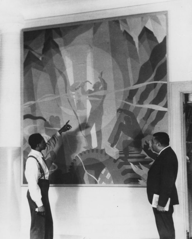 Artist Aaron Douglas, left, shows Arturo Alfonso Schomburg his painting, "Aspects of Negro Life: Song of the Towers" in 1934.