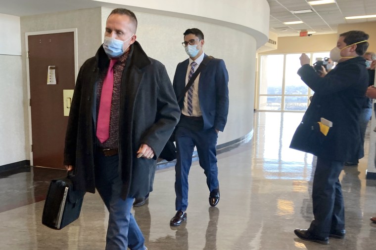 Brett Hankison, left, exits the courtroom after the first day of jury selection in his trial on Feb. 8, 2022, in Louisville, Ky.