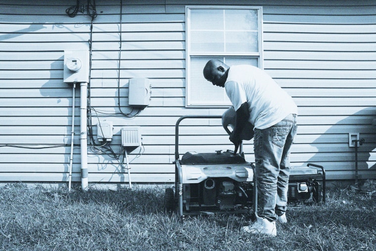 Image: A man fills a generator with gas on Sept. 2, 2021 in Hammond, La.