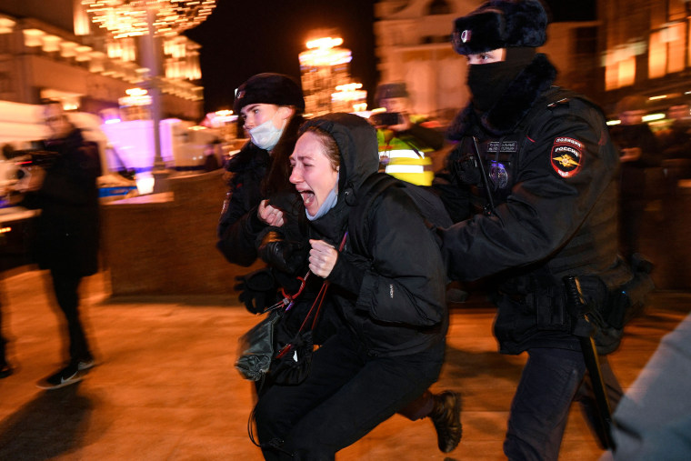 Image: Police detain a demonstrator during a protest in Moscow on February 24, 2022.
