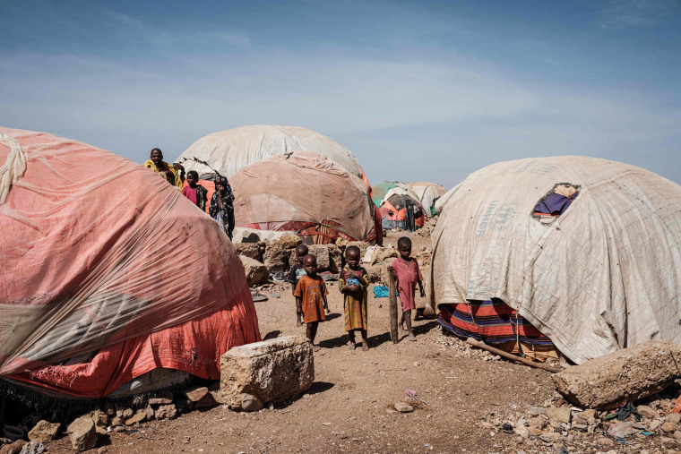 Image: Children stand between makeshift tents woman at a camp for internally displaced persons (IDPs) in Baidoa, Somalia, on Feb. 13, 2022.