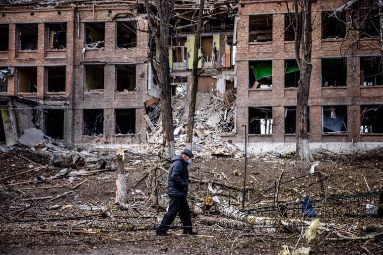 A man walks in front of a destroyed building after a Russian missile attack in the town of Vasylkiv, near Kyiv, on Feb. 27, 2022.