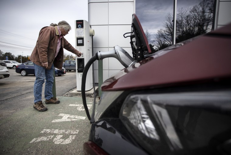 A man charges his Nissan Leaf at a CHAdeMO station on March 9, 2020 in Portland, Maine.