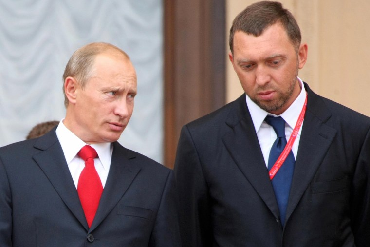Then Russian Prime Minister Vladimir Putin speaks with Oleg Deripaska at the International Investment Forum in Sochi, Russia, in 2008.