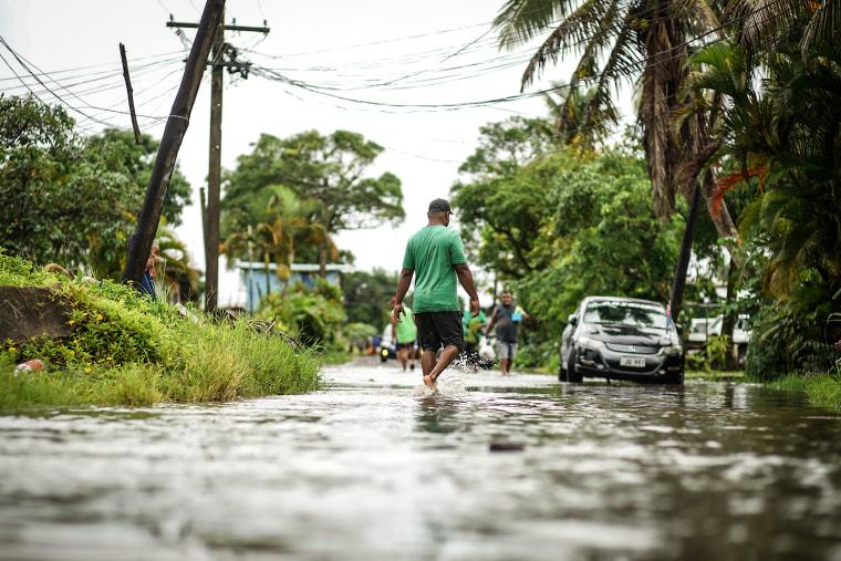 Residents wade through the flooded streets in Fiji's capital city of Suva on Dec. 16, 2020, ahead of super Cyclone Yasa.