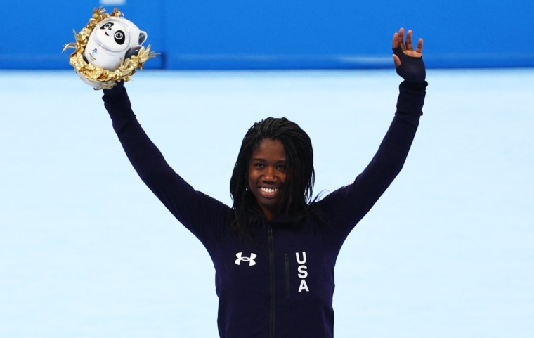Gold medalist Erin Jackson celebrates on the podium during the flower ceremony on Feb. 13, 2022.