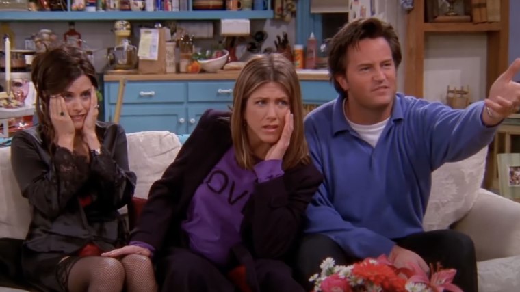 Monica, Rachel and Chandler grimace at a video of a woman giving birth.