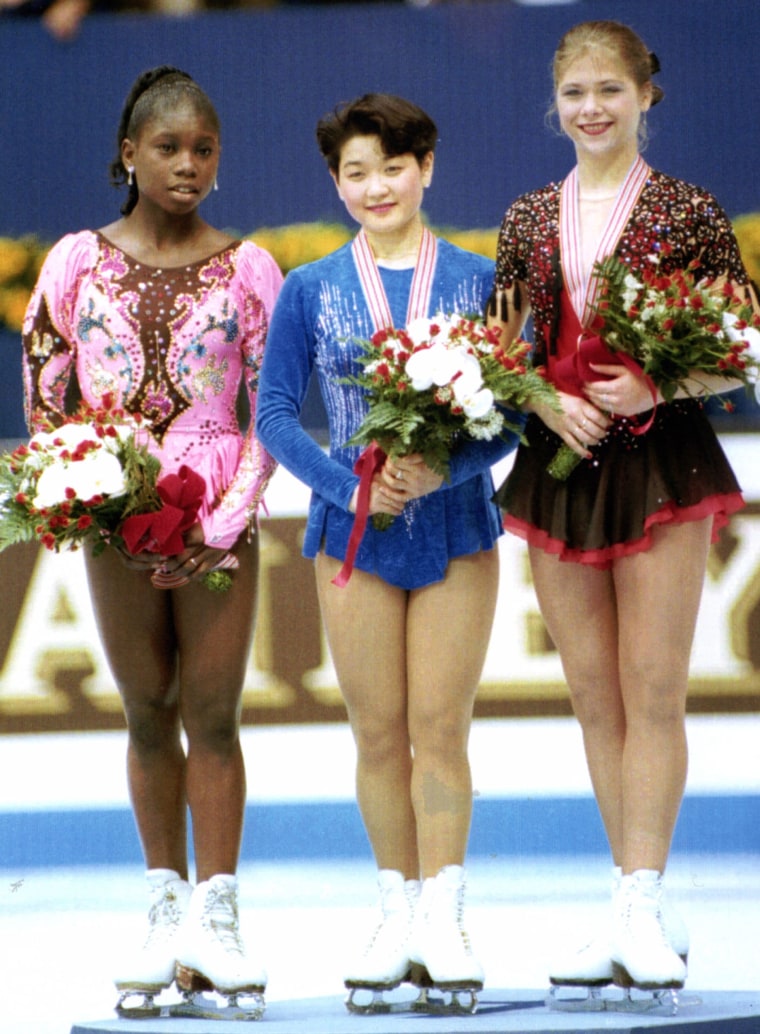 Bonaly, left, unhappy with the judging, refuses to wear the silver medal when she stands with other winners of the women's figure skating at the award presentation during the World Figure Skating Championships in Chiba, east of Tokyo, on March 26, 1994. Japan's Yuka Sato, center, won the championship and Germany's Tanja Sczewczenko won the bronze winner. 