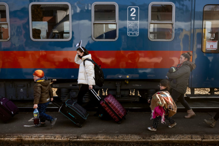 Cientos de personas llegan a la estación de tren tras cruzar la frontera en Zahony-Csap mientras huyen de Ucrania el 27 de febrero de 2022 en Zahony, Hungría.