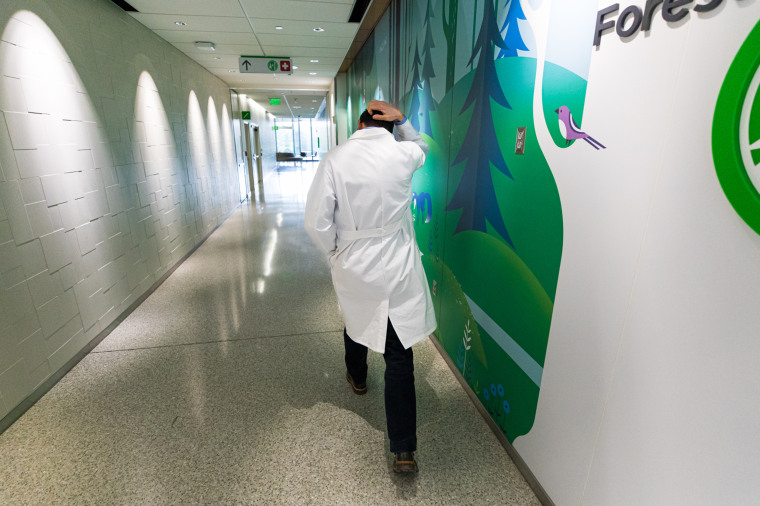 Dr. John McGuire walks toward the pediatric intensive care unit at Seattle Children’s Hospital on Jan. 28, 2022. “We continue to message that vaccination for kids who are eligible is the best preventive measure against severe disease, along with good public health measures," McGuire said. 